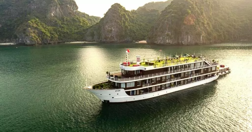 La Casta Regal Cruise sailing through Halong Bay at sunset, aerial view