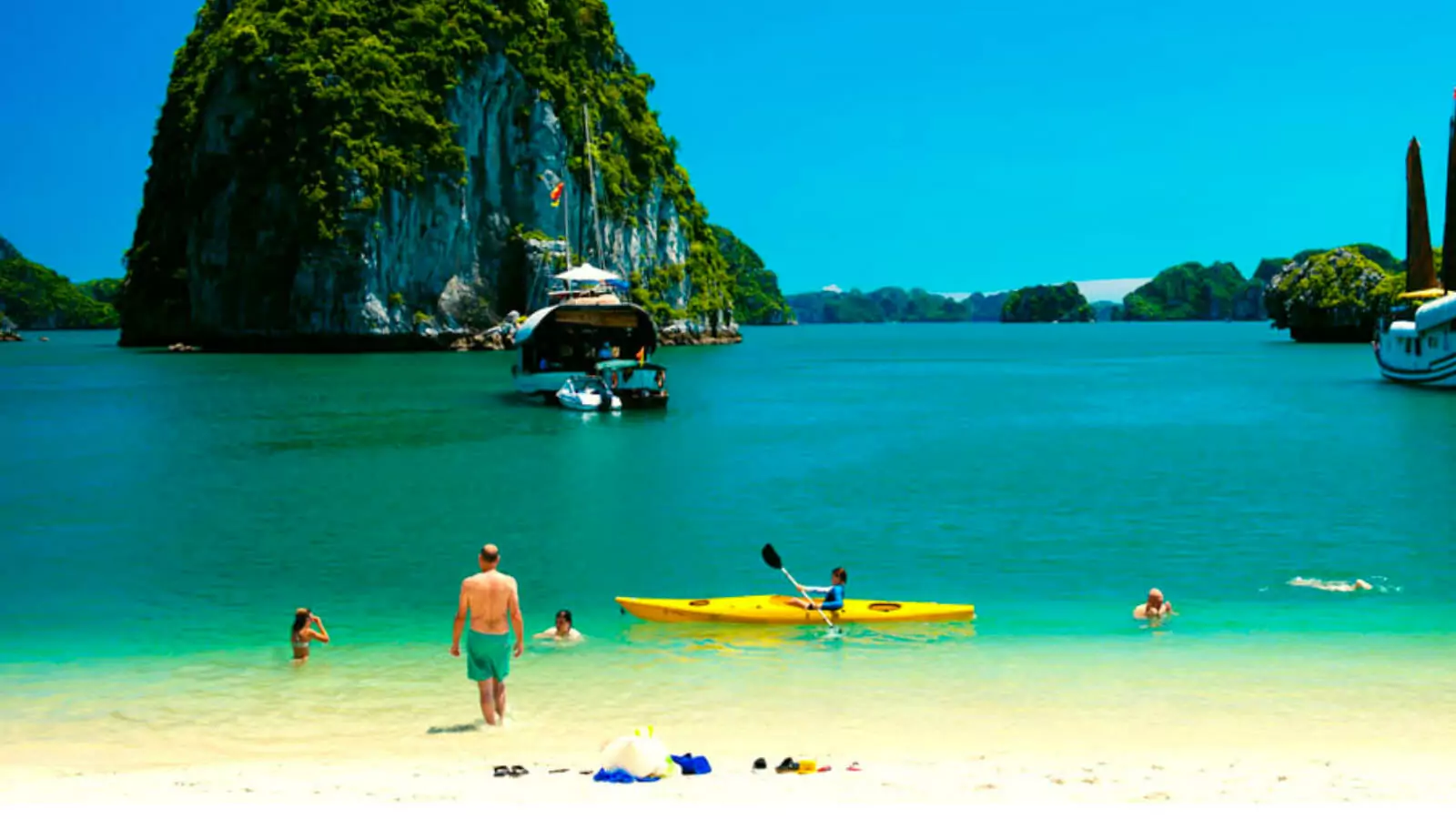 Ba Trai Dao Beach white sand at low tide — the crescent beach enclosed by three limestone islets is accessible for only 2-3 hours daily, Lan Ha Bay Vietnam