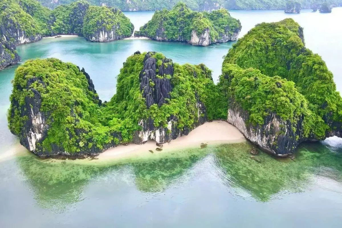 Ba Trai Dao Islets (Three Peaches Beach) — three crescent white sand beaches separated by limestone cliffs, Lan Ha Bay, Vietnam
