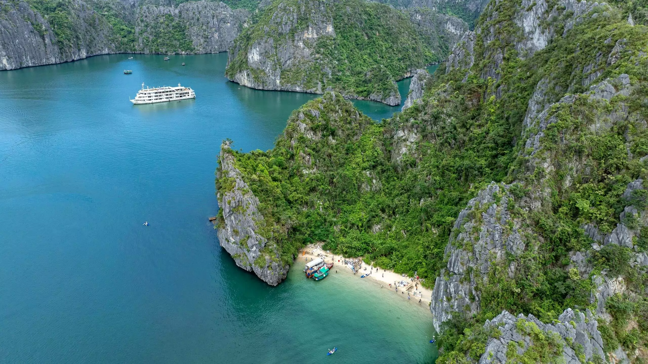 Cap La Island's pristine white sand beach with crystal-clear emerald water -- one of Bai Tu Long Bay's most unspoiled and uncrowded swimming beaches