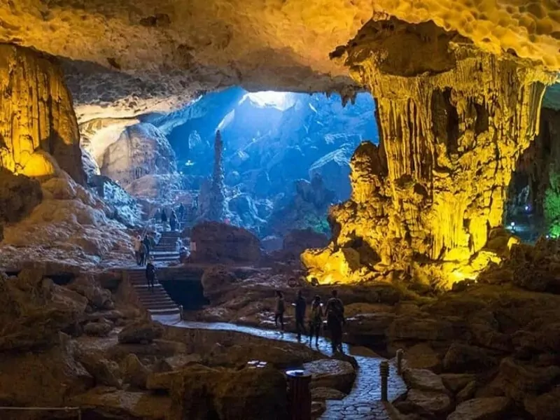 Dau Go Cave's bright first chamber with towering stalactite columns resembling silent guardians, Halong Bay