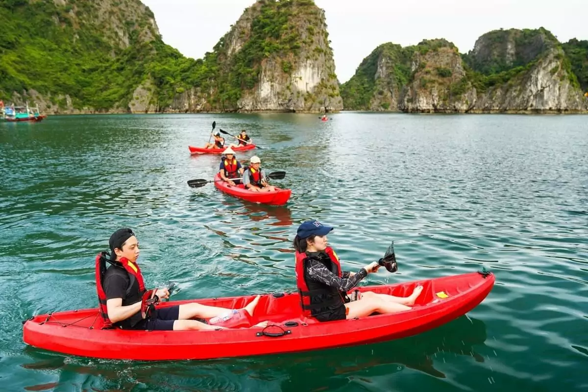 Kayaking through Cong Dam Area's tranquil limestone karst corridor, Bai Tu Long Bay's signature activity, Vietnam