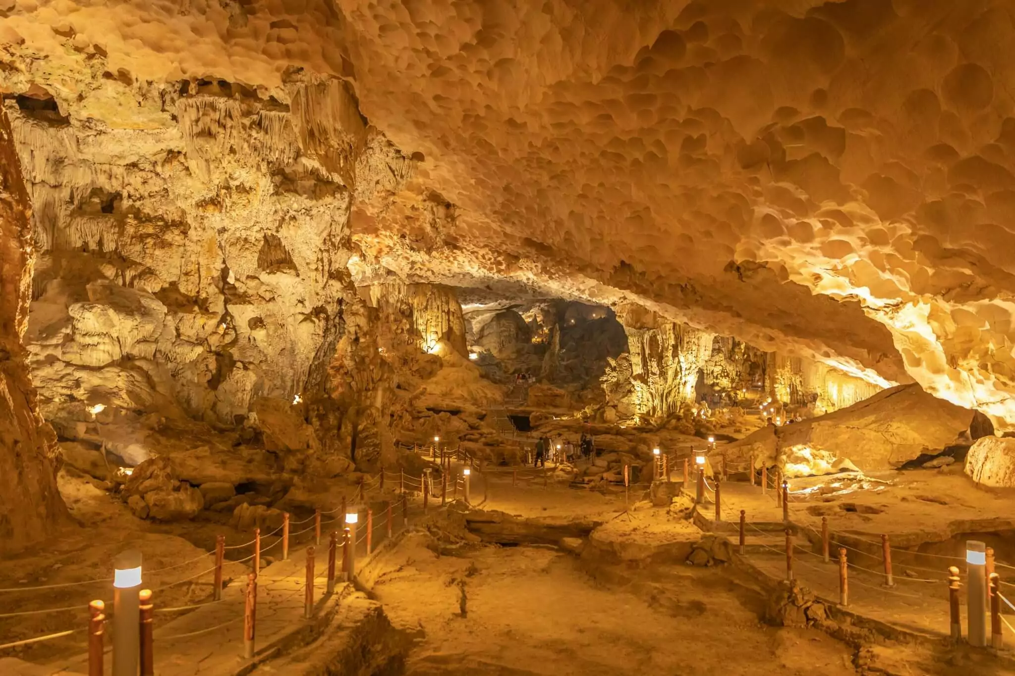 Sung Sot Cave second chamber "Grand Hall" — 30-meter high ceiling with massive stalactites and stalagmites shaped like Buddha and animals, Halong Bay Vietnam