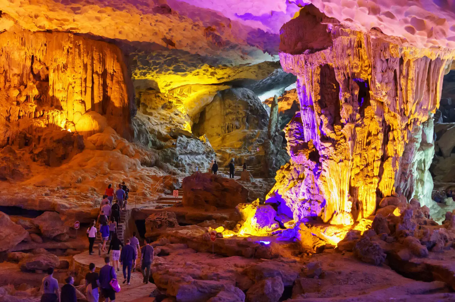 Inside Sung Sot Cave (Surprise Cave) — massive stalactites and stalagmites in the Grand Hall chamber, Halong Bay's largest cave, Vietnam