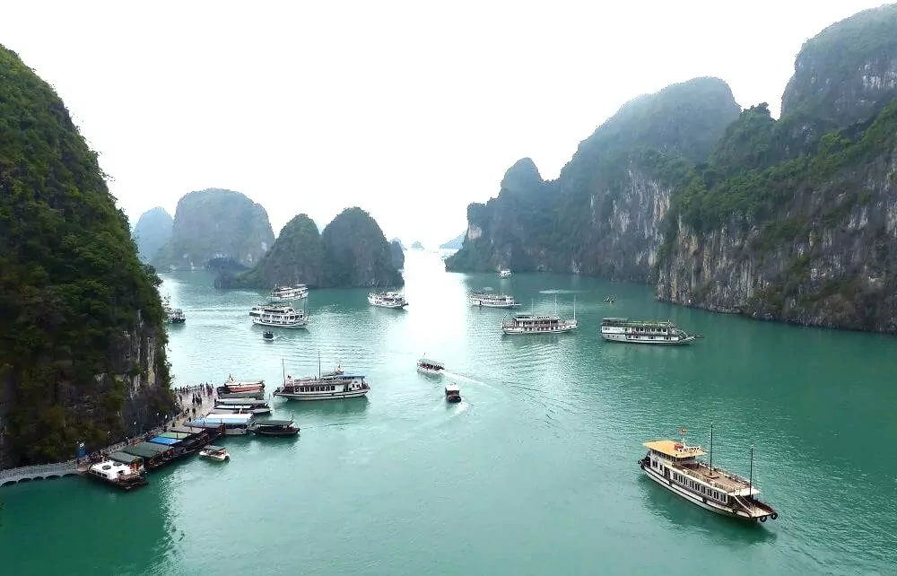 Panoramic viewpoint at Sung Sot Cave exit — sweeping view of Halong Bay limestone islands and emerald waters, Vietnam