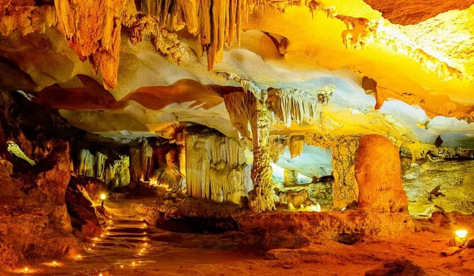 Inside Thien Canh Son Cave — limestone stalactite formations across three chambers, Bai Tu Long Bay's only major cave, Vietnam