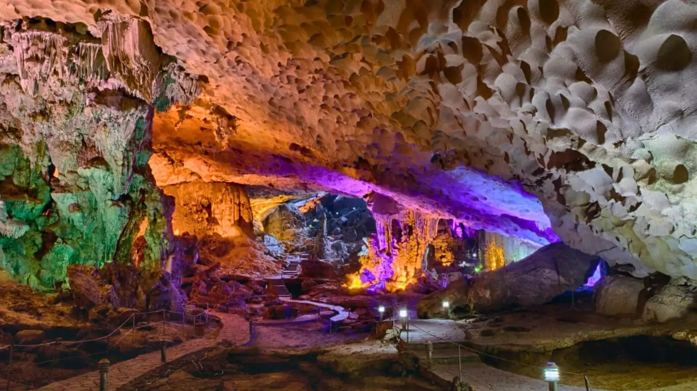 Thien Cung Cave's three clear ponds in the third chamber, reflecting colorful cave lighting, Halong Bay Vietnam
