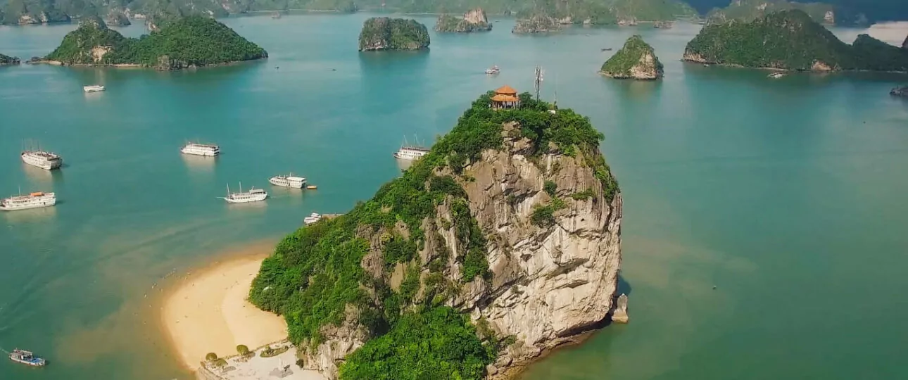 Ti Top Island (Titov Island) aerial view — crescent beach and limestone karsts of Halong Bay, Vietnam