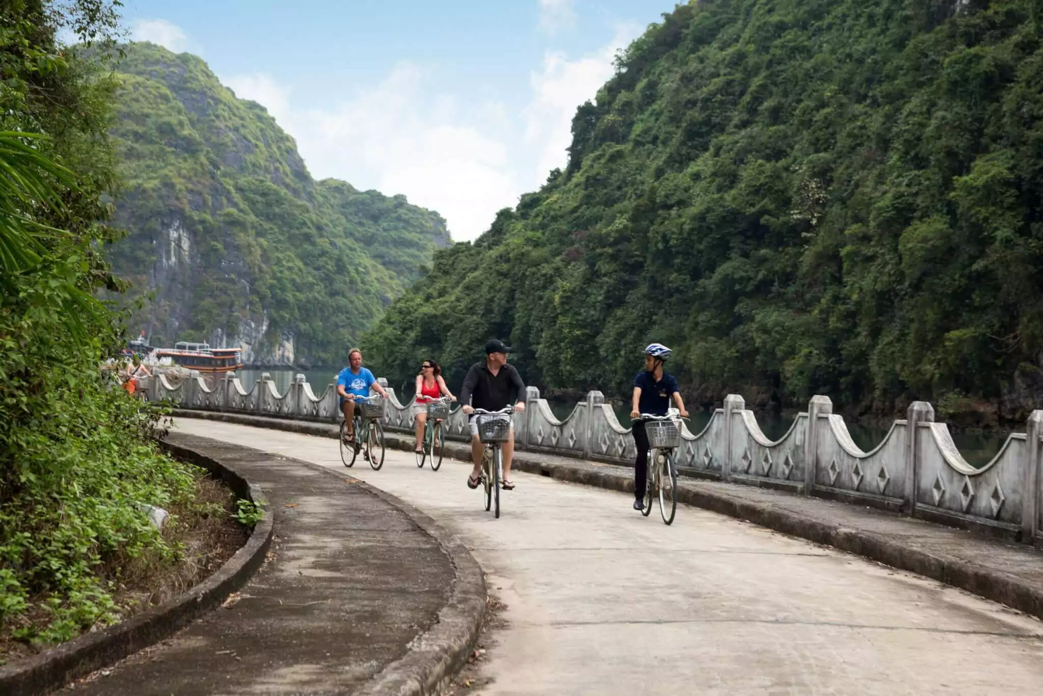 Cycling through rice paddies in Viet Hai Village, an ancient community hidden inside Cat Ba National Park, Lan Ha Bay Vietnam