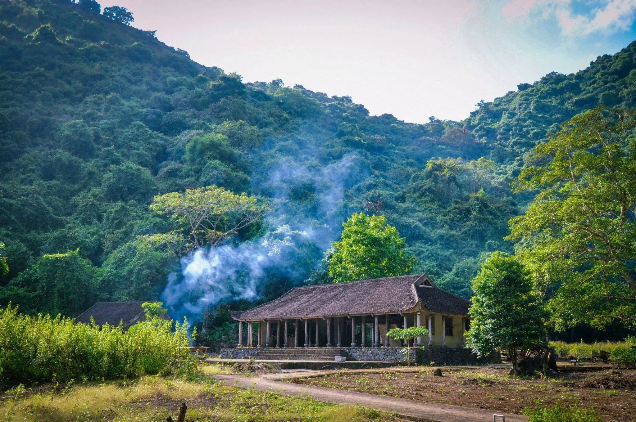 Traditional wooden houses in Viet Hai Village with open unlocked doors — the famous no-lock culture of Cat Ba Island's hidden valley community