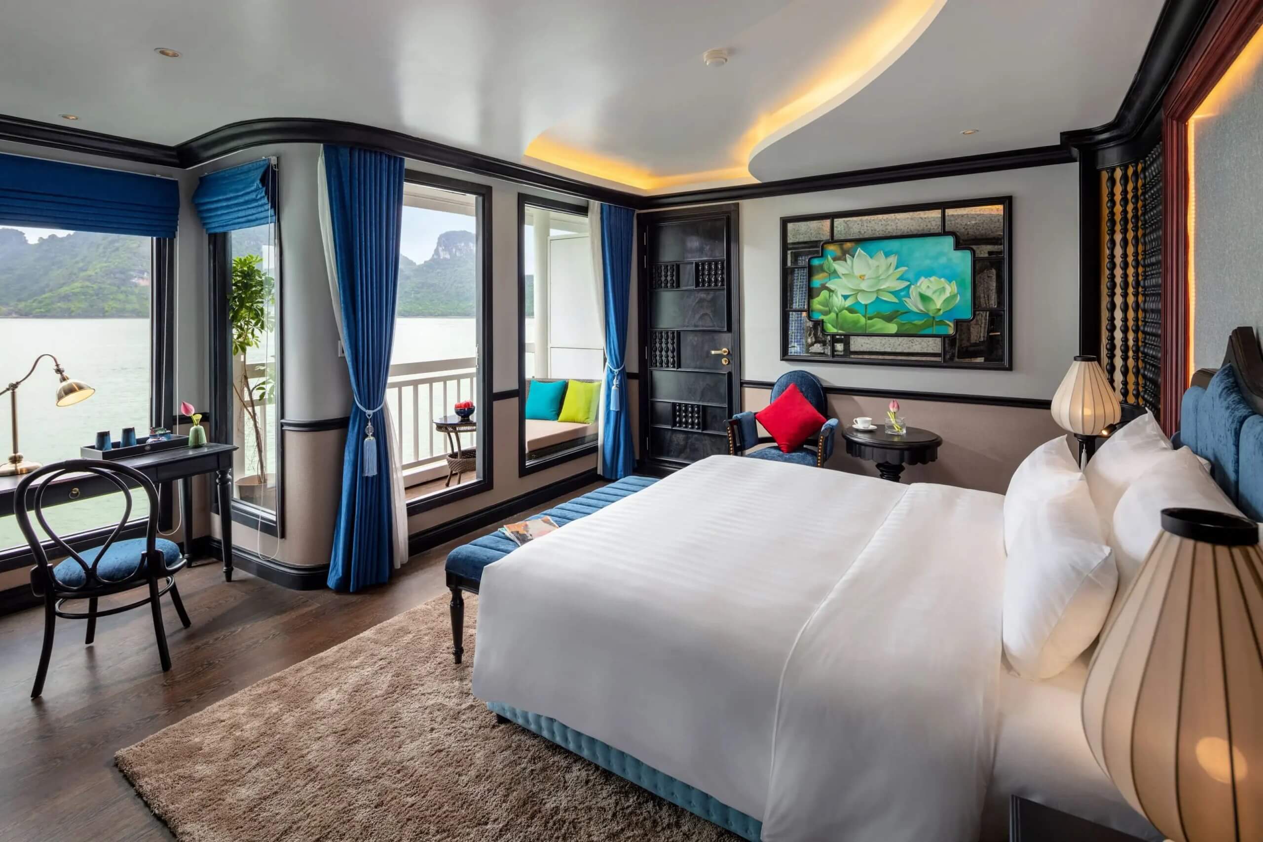 Aurora Cruise Deluxe Cabin interior with king bed, private balcony, and bay view, Lan Ha Bay