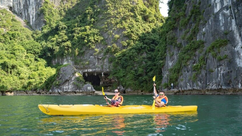 Guests kayaking near Luon Cave on Amanda Cruise Halong Bay itinerary