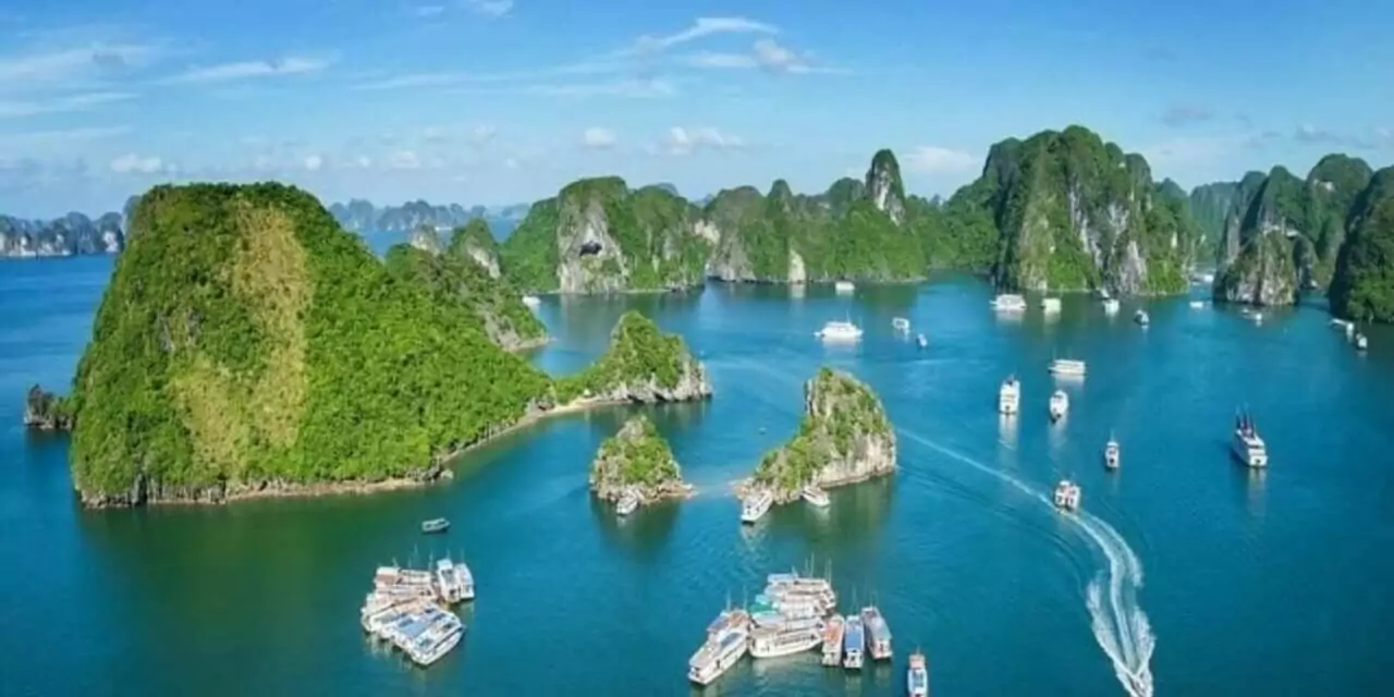 Multiple cruise boats anchored in Halong Bay's main tourist area