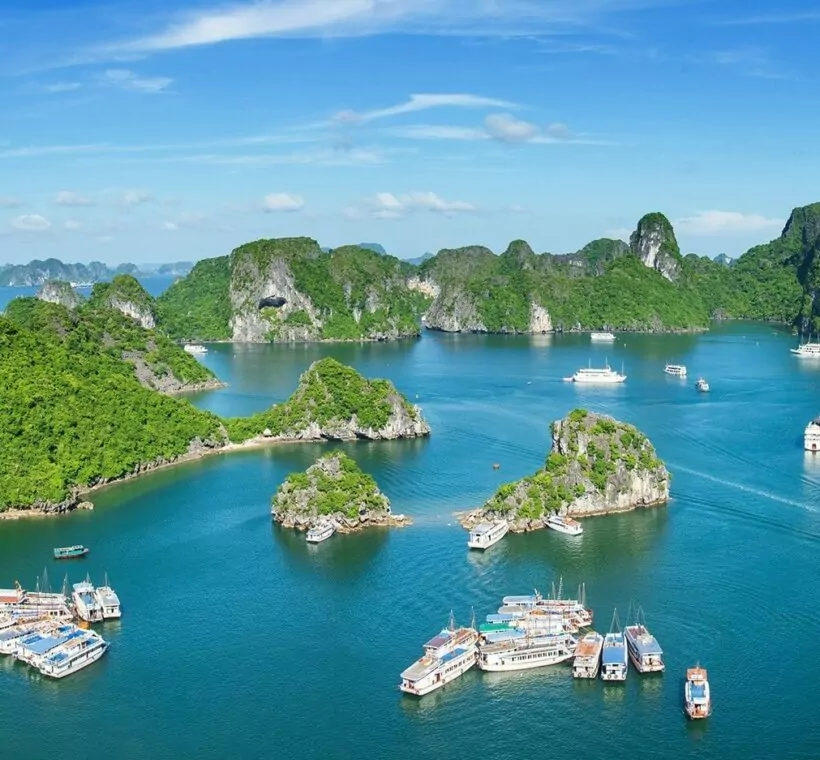 Halong Bay at sunrise during autumn, the best time to visit for clear skies and calm water
