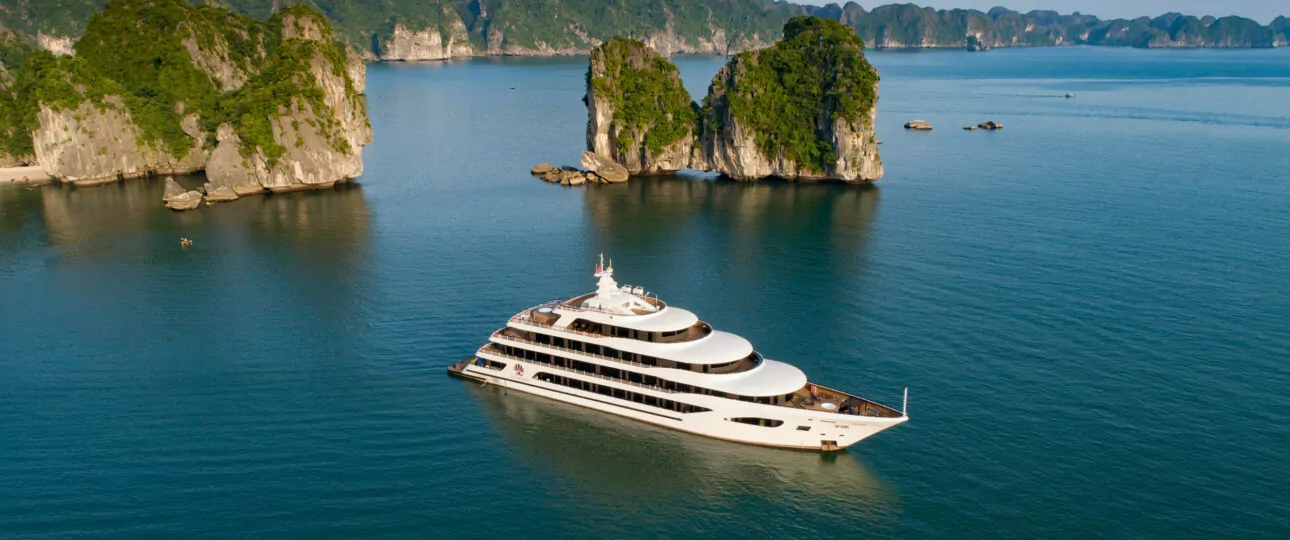 Scarlet Pearl Cruise sailing through Lan Ha Bay, Halong Bay, Vietnam – aerial view of the luxury 5-star cruise ship