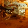 Thien Canh Son Cave interior — stalactite formations resembling lotus flowers and chandeliers, Bai Tu Long Bay's most spectacular cave, Vietnam