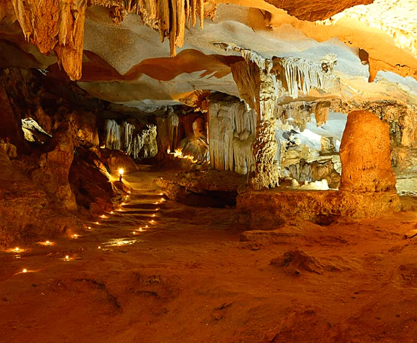 Thien Canh Son Cave interior — stalactite formations resembling lotus flowers and chandeliers, Bai Tu Long Bay's most spectacular cave, Vietnam