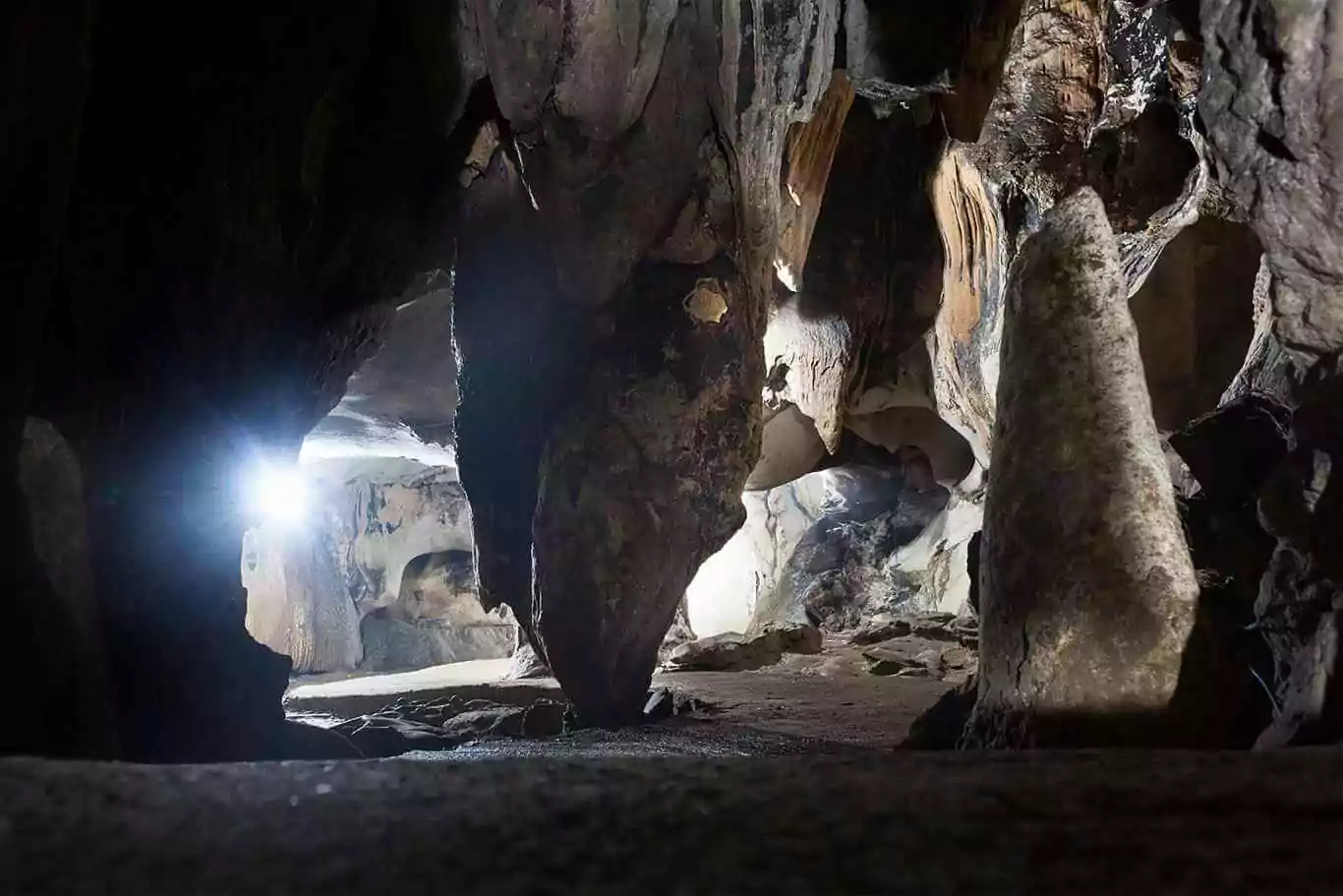 Trung Trang Cave interior — ancient stalactite formations inside a 300-meter limestone tunnel, Cat Ba Island Vietnam