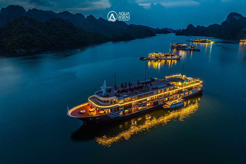 Aqua Of The Seas Cruise among other cruise ships in Halong Bay at twilight
