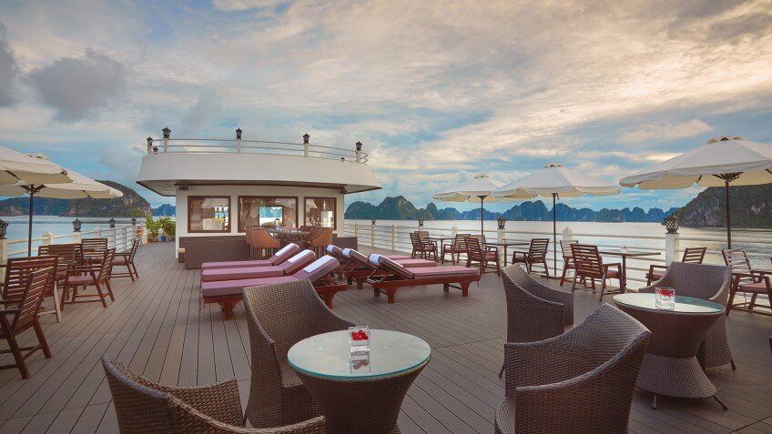 Sundeck lounge chairs on Athena Luxury Cruise overlooking Halong Bay