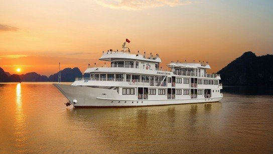 Athena Luxury Cruise sailing Halong Bay at sunset, exterior view of the 5-star ship