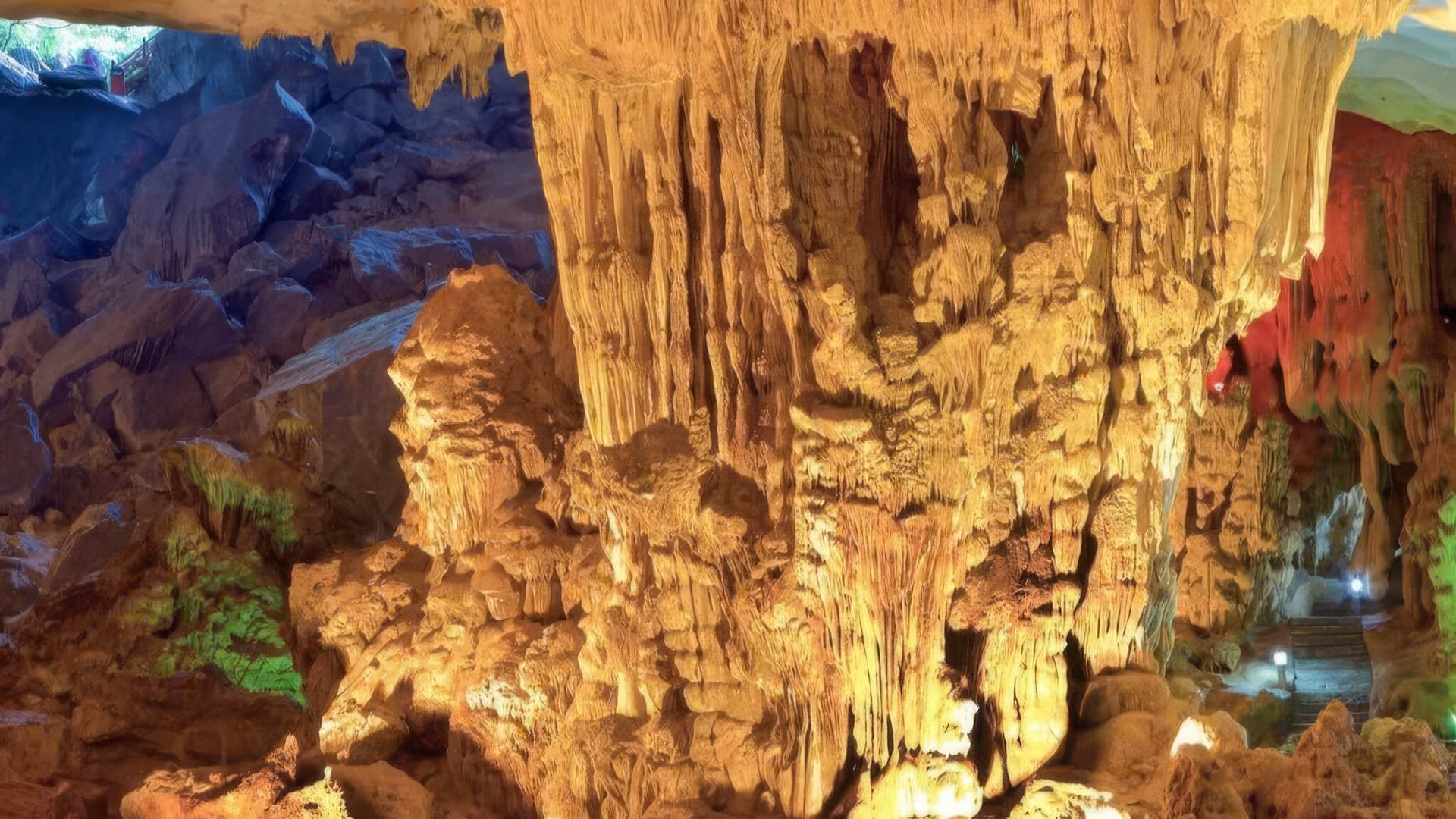 Illuminated stalactite formations inside Sung Sot Cave, visited from Catherine Cruise Halong Bay