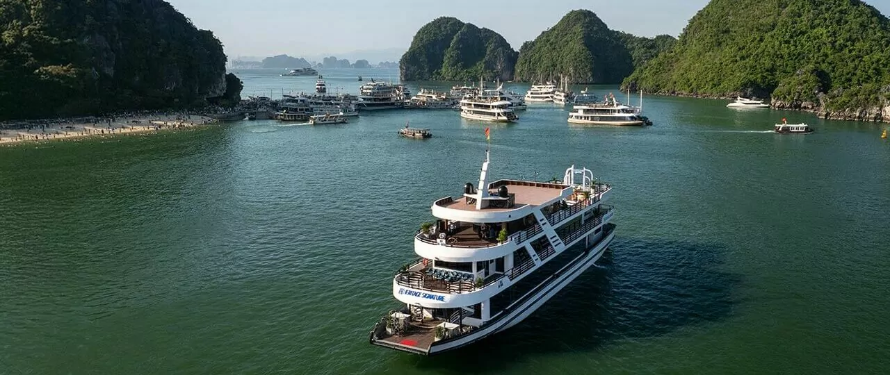 Halong Heritage Signature Day Cruise aerial view sailing near Ti Top Island beach, Halong Bay