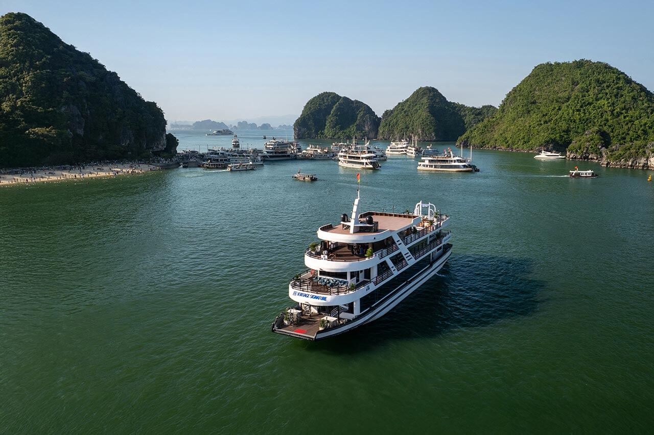 Halong Heritage Signature Day Cruise aerial view sailing near Ti Top Island beach, Halong Bay