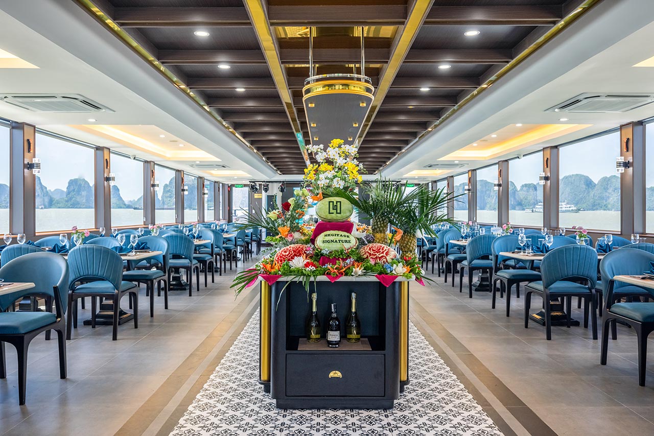 Two-floor restaurant interior with Heritage Signature centerpiece, Halong Heritage Signature Day Cruise