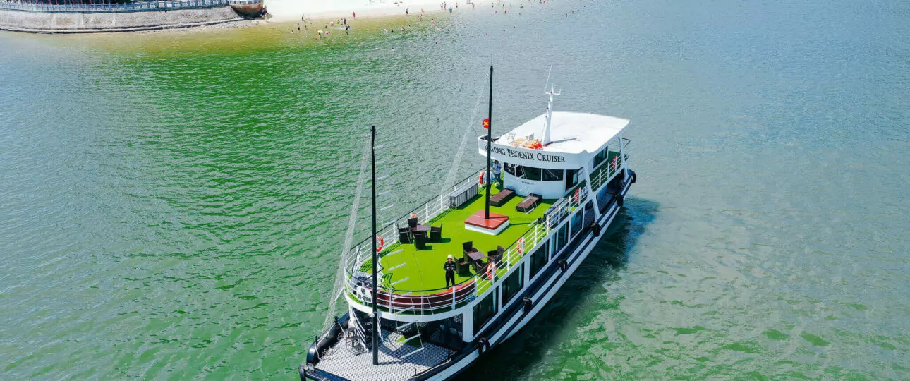 Aerial view of Halong Phoenix Day Cruise sailing near Ti Top Island in Halong Bay