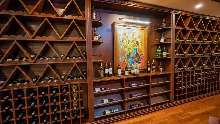 The Bach Dang Wine Cellar on Heritage Binh Chuan Cruise, stocked with a curated wine selection.