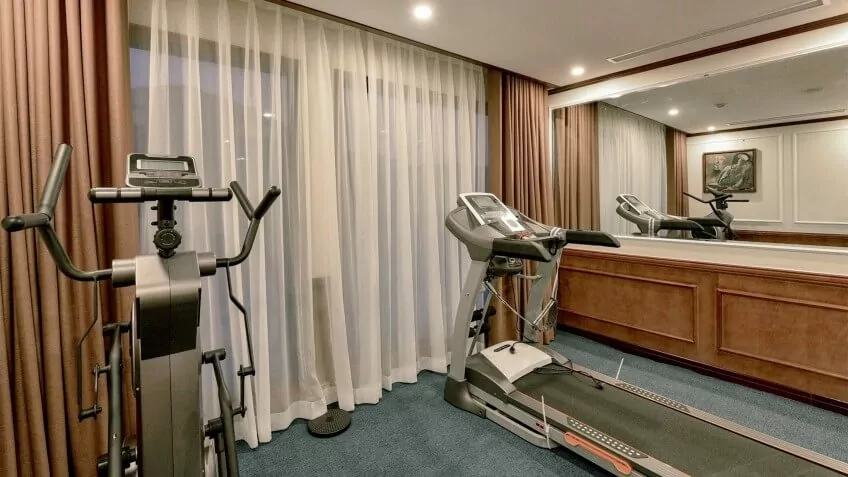 The onboard fitness center on Heritage Binh Chuan Cruise, equipped with cardio machines.