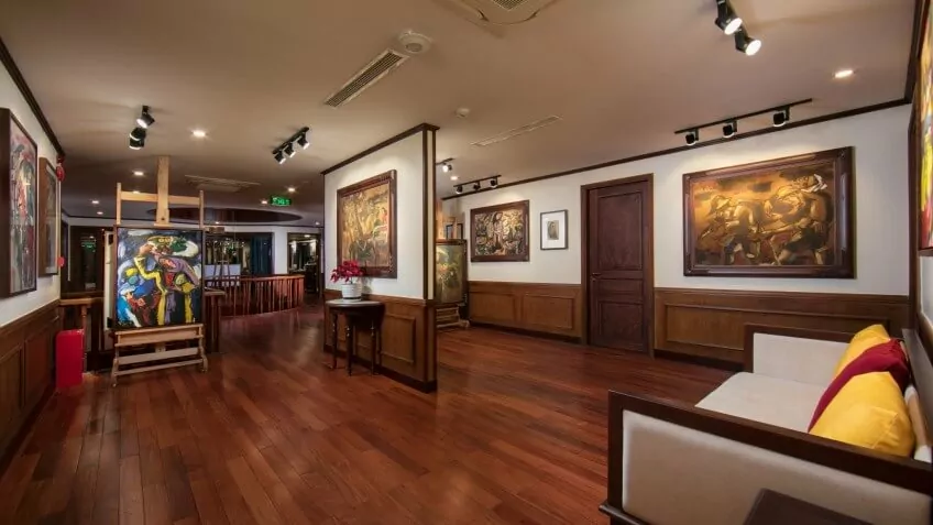 L'Art de l'Annam, the onboard art gallery on Heritage Binh Chuan Cruise, displaying Vietnamese paintings.