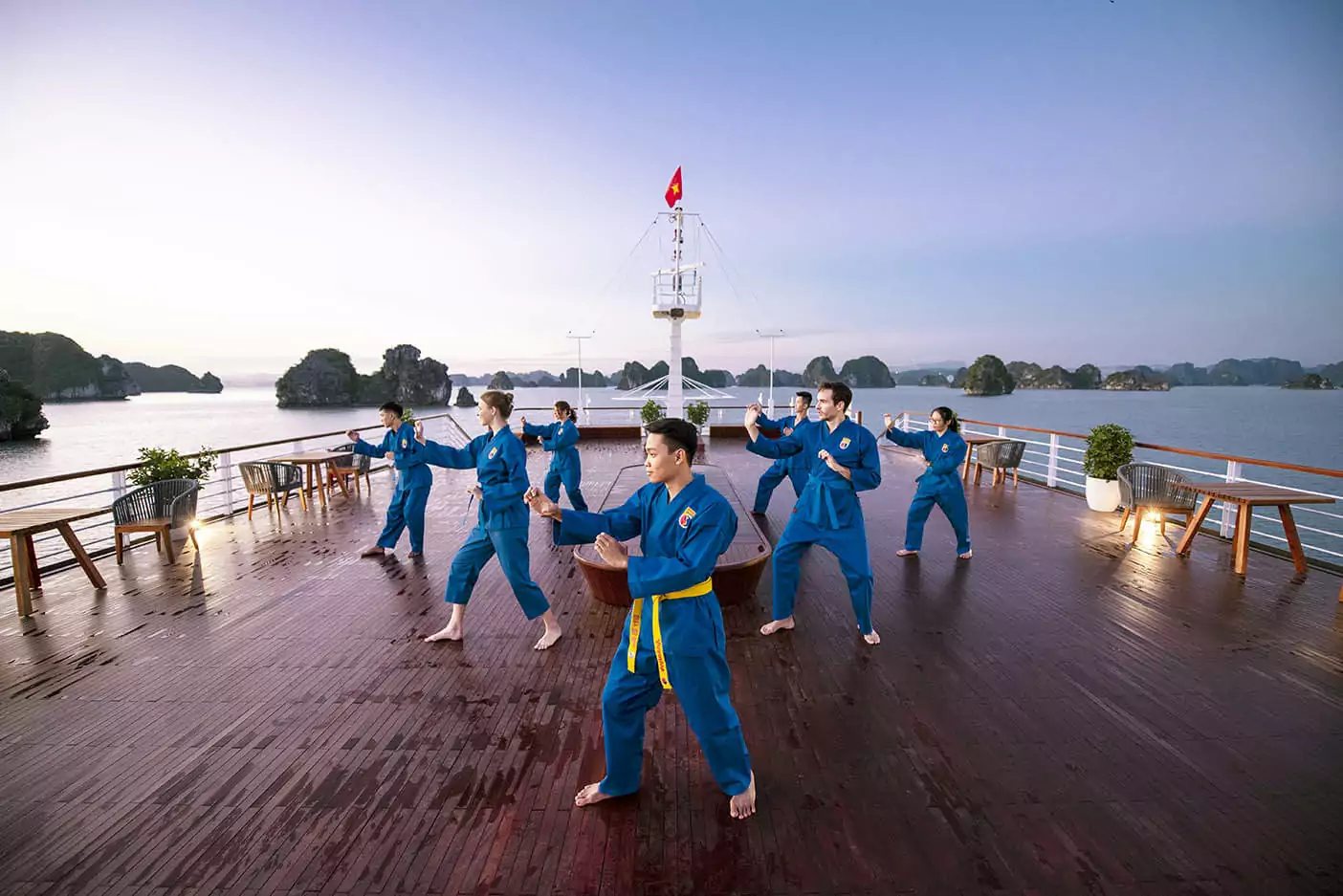A Vovinam (Vietnamese martial arts) session on the sundeck of Heritage Binh Chuan Cruise at sunrise.