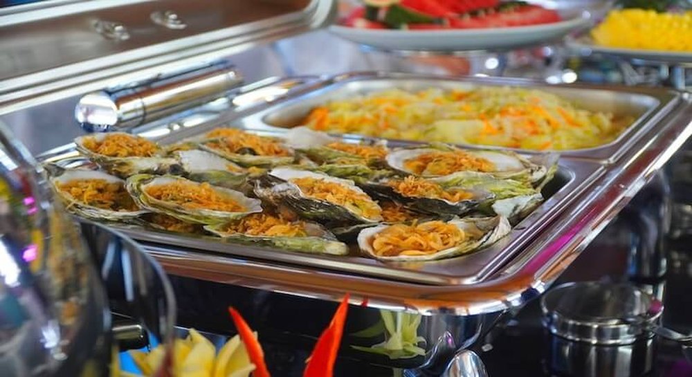 Grilled oysters served on the buffet
