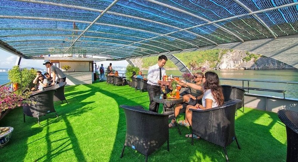 Guests relaxing on the shaded sundeck overlooking Halong Bay