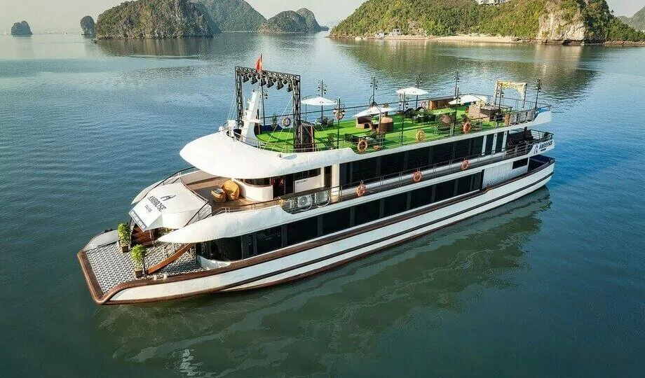 Ambrose Day Cruise anchored in Halong Bay seen from aerial drone view