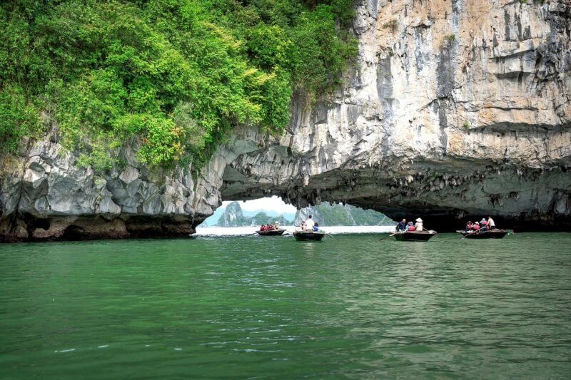 Traditional bamboo boat rowing near Luon Cave on Ambrose Day Cruise
