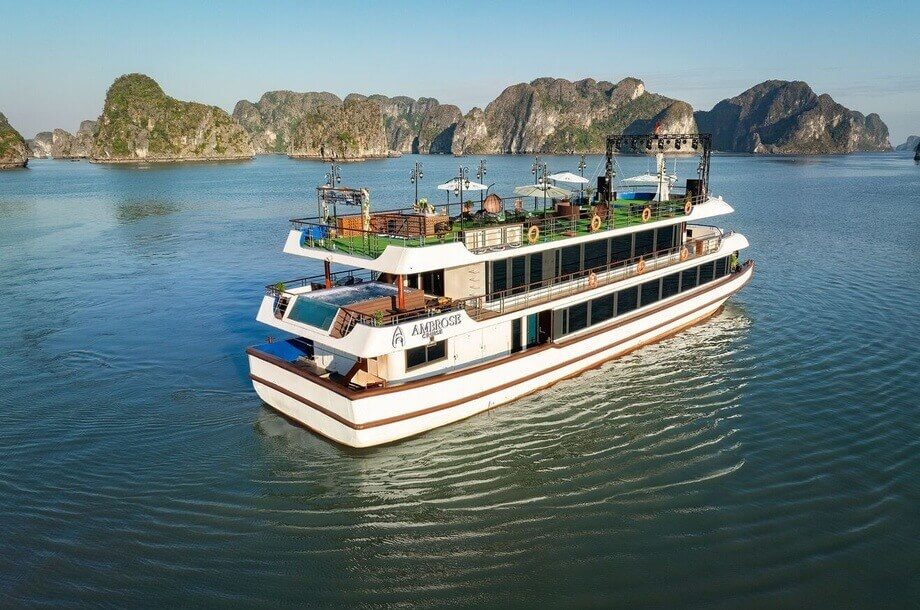 Ambrose Day Cruise exterior cruising past limestone karsts in Halong Bay