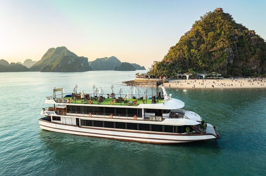 Sunset over a secluded beach stop on the Ambrose Day Cruise Halong Bay itinerary