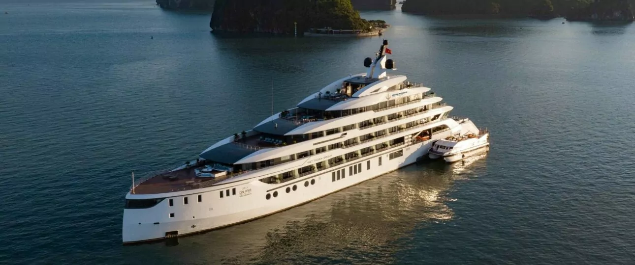 Grand Pioneers Cruise Halong Bay 1 luxury cruise ship sailing at sunset among limestone karsts