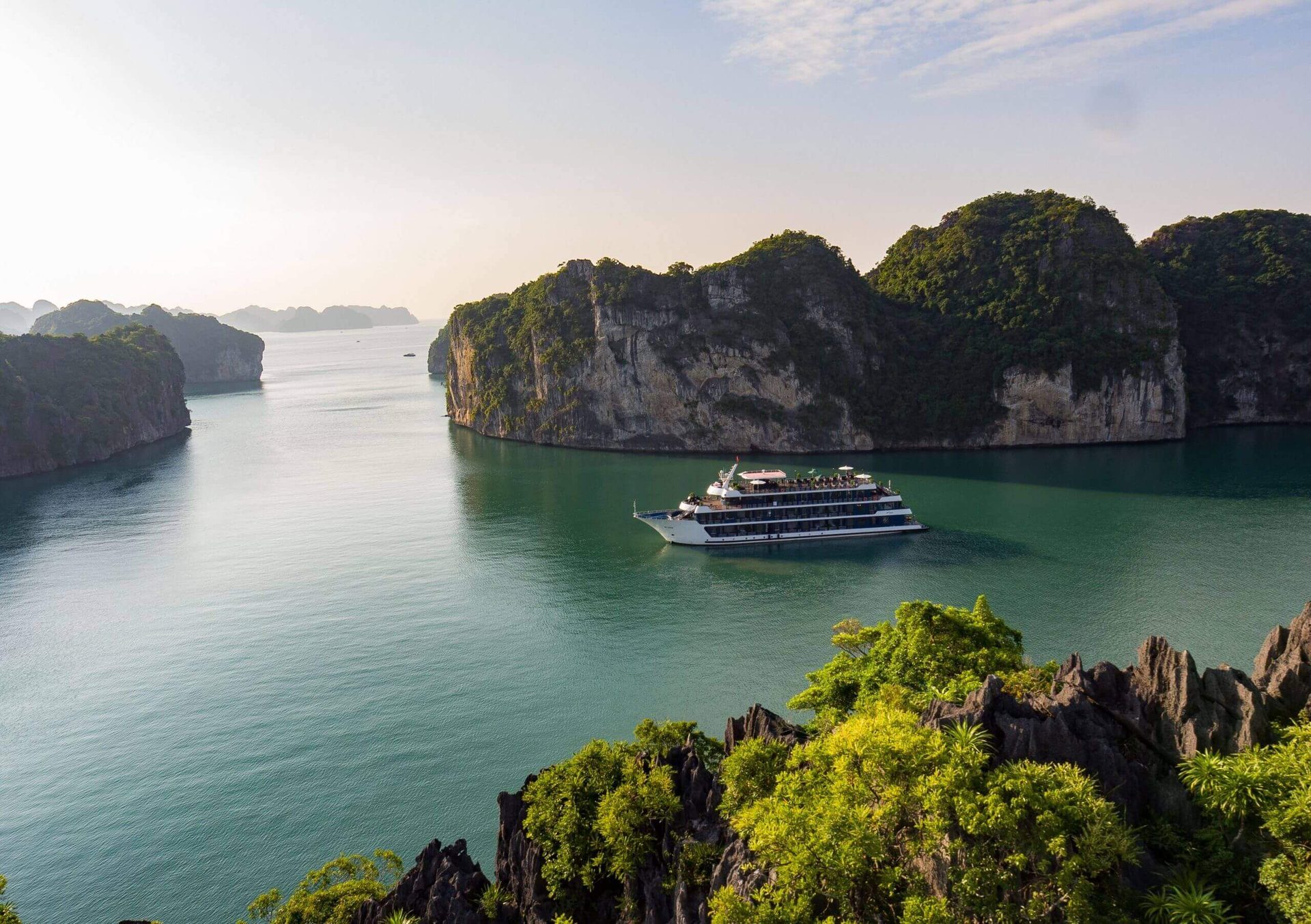 Golden sunrise over Rosy Cruise as it drifts through Halong Bay.