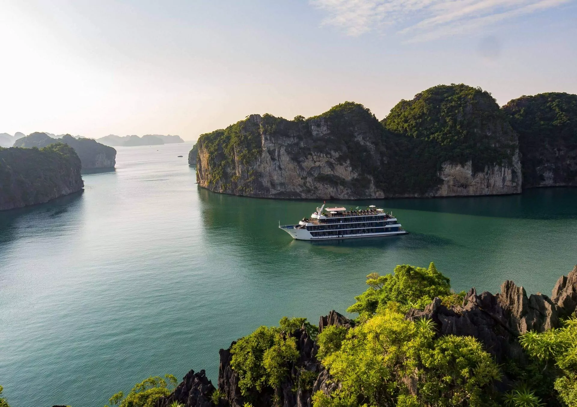 Golden sunrise over Rosy Cruise as it drifts through Halong Bay.