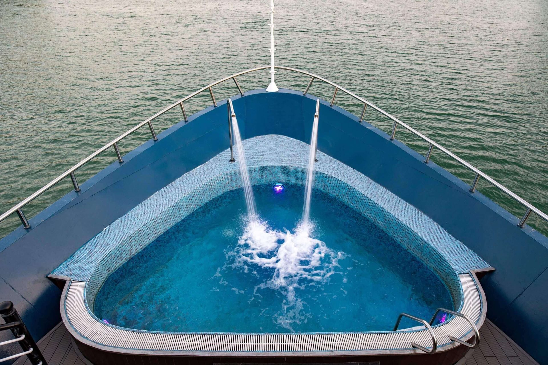 Guests can relax in Rosy Cruise's outdoor bow jacuzzi while cruising Halong Bay.
