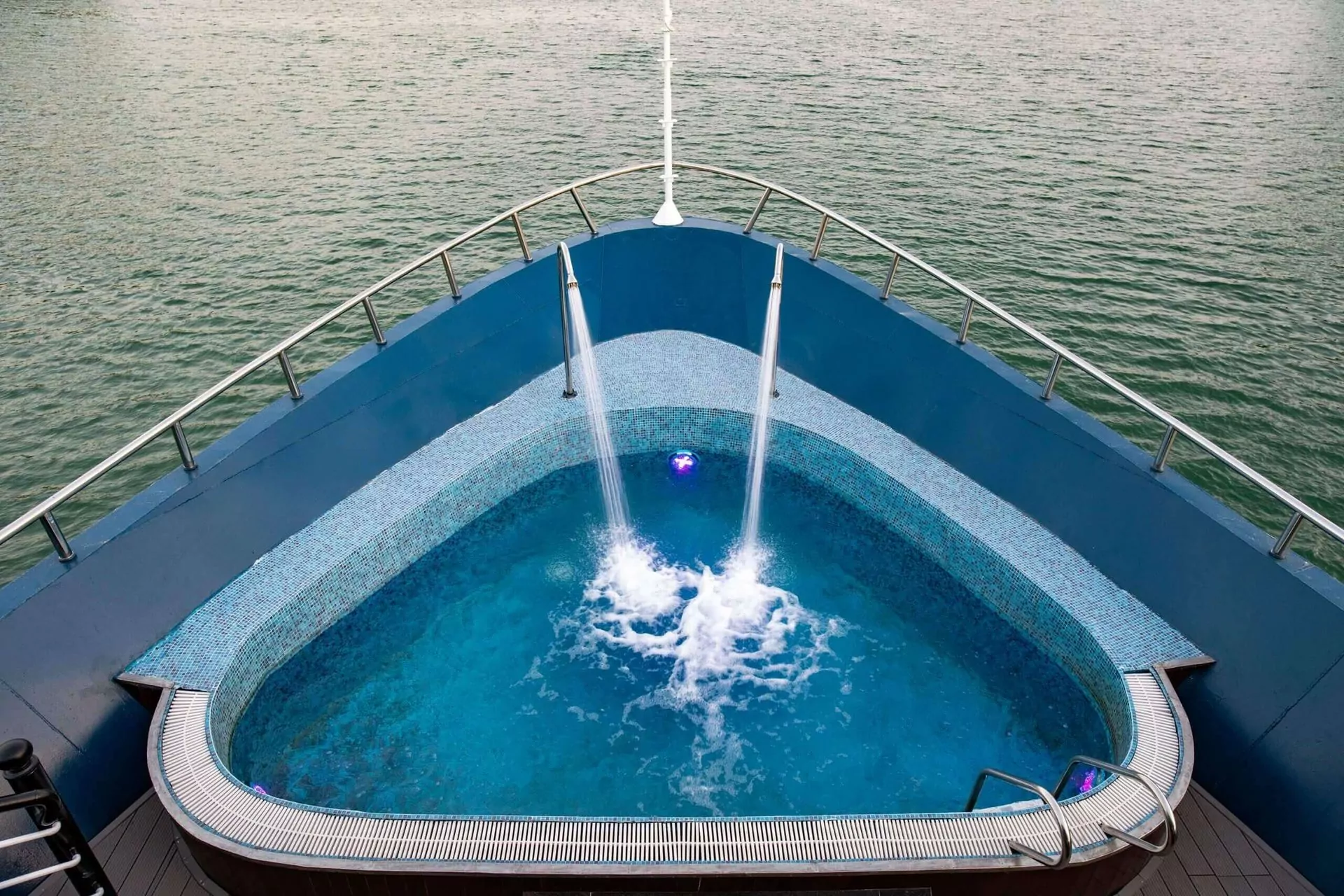 Guests can relax in Rosy Cruise's outdoor bow jacuzzi while cruising Halong Bay.