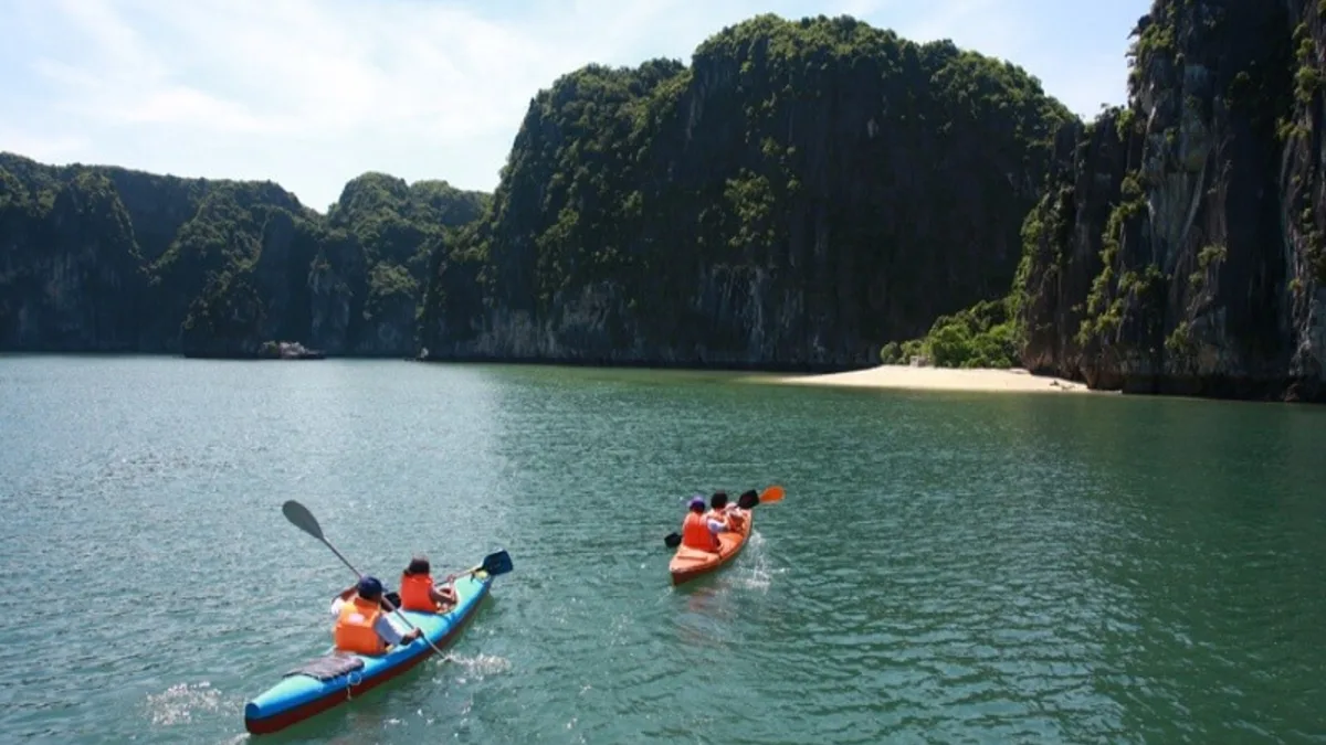 Kayaking through Ao Ech Area (Frog Pond) -- Lan Ha Bay's mirror-calm enclosed lagoon surrounded by towering limestone karsts, Vietnam