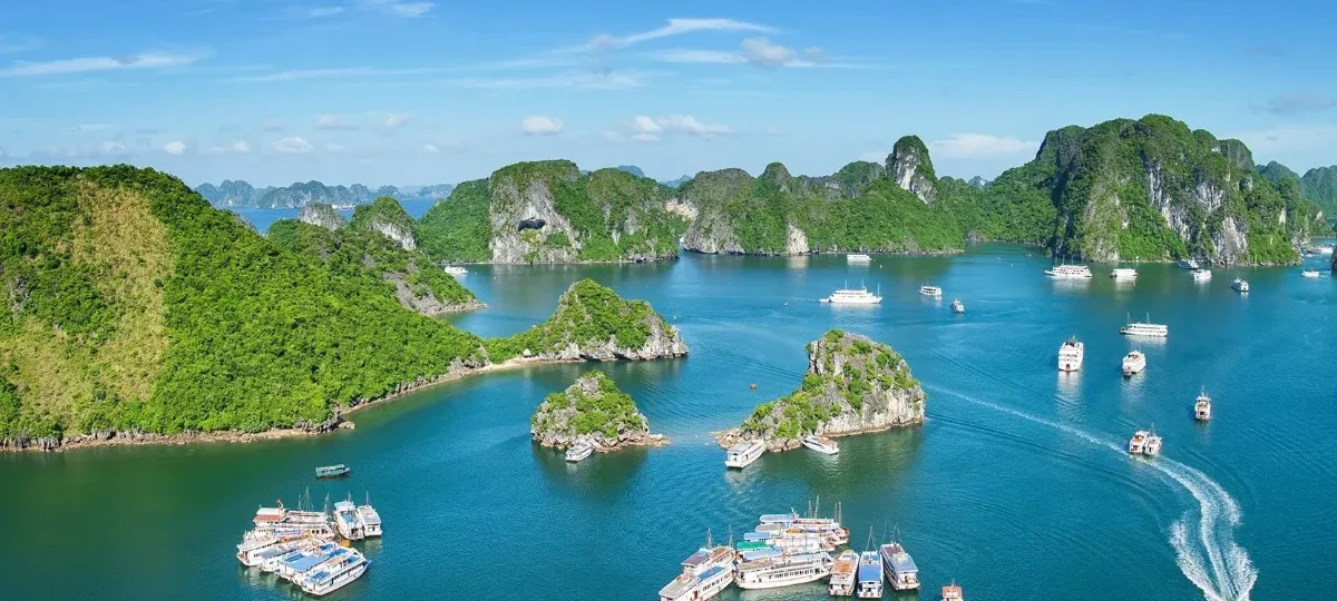 Best time to visit Halong Bay: sunrise over the limestone islands on a clear autumn morning