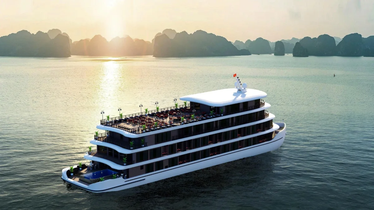 Cycad Grand Cruise at Sunset in Bai Tu Long Bay Cycad Grand Cruise sailing at sunset with karst islands on the horizon