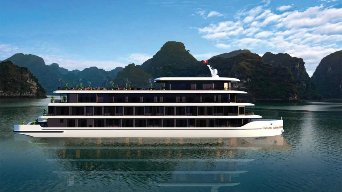 Cycad Grand Cruise Ship Exterior Side view of Cycad Grand Cruise with its balcony decks in front of limestone karsts