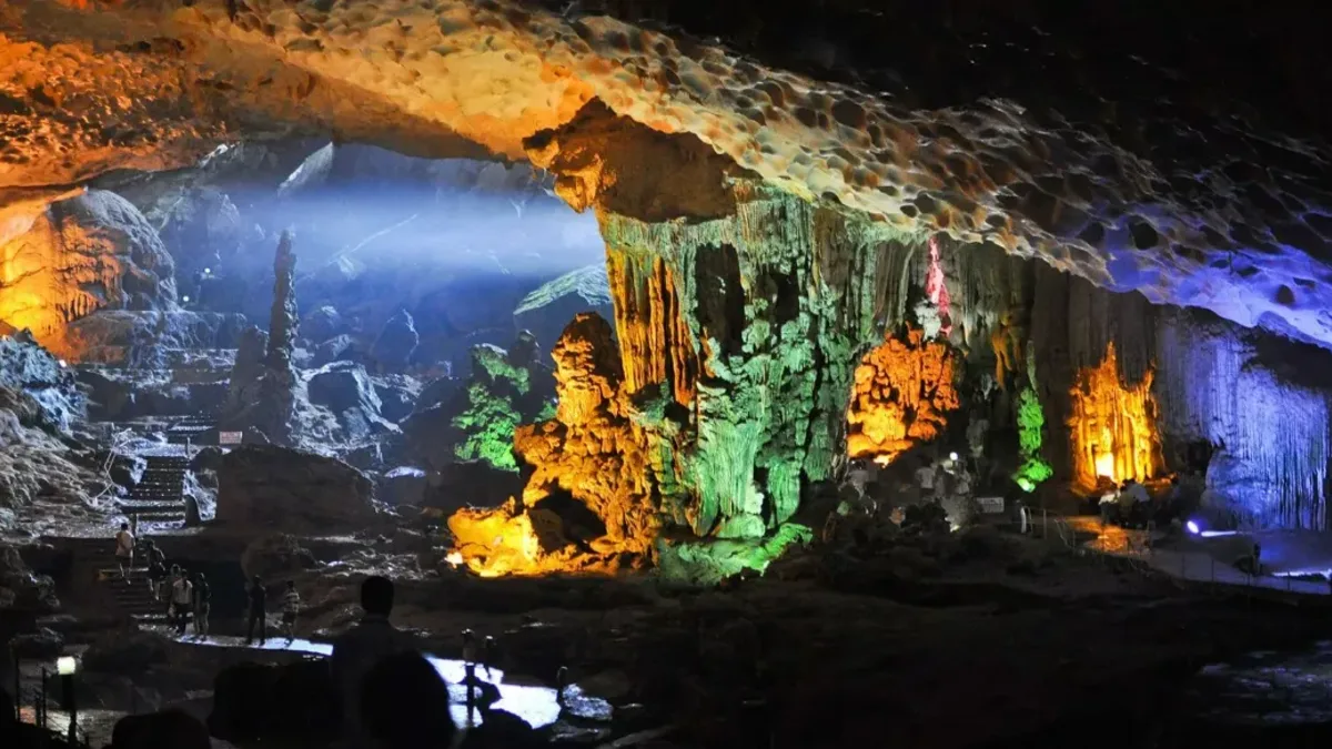 Stone stairway leading to Dau Go Cave's wide jellyfish-shaped entrance on Dau Go Island, Halong Bay Vietnam